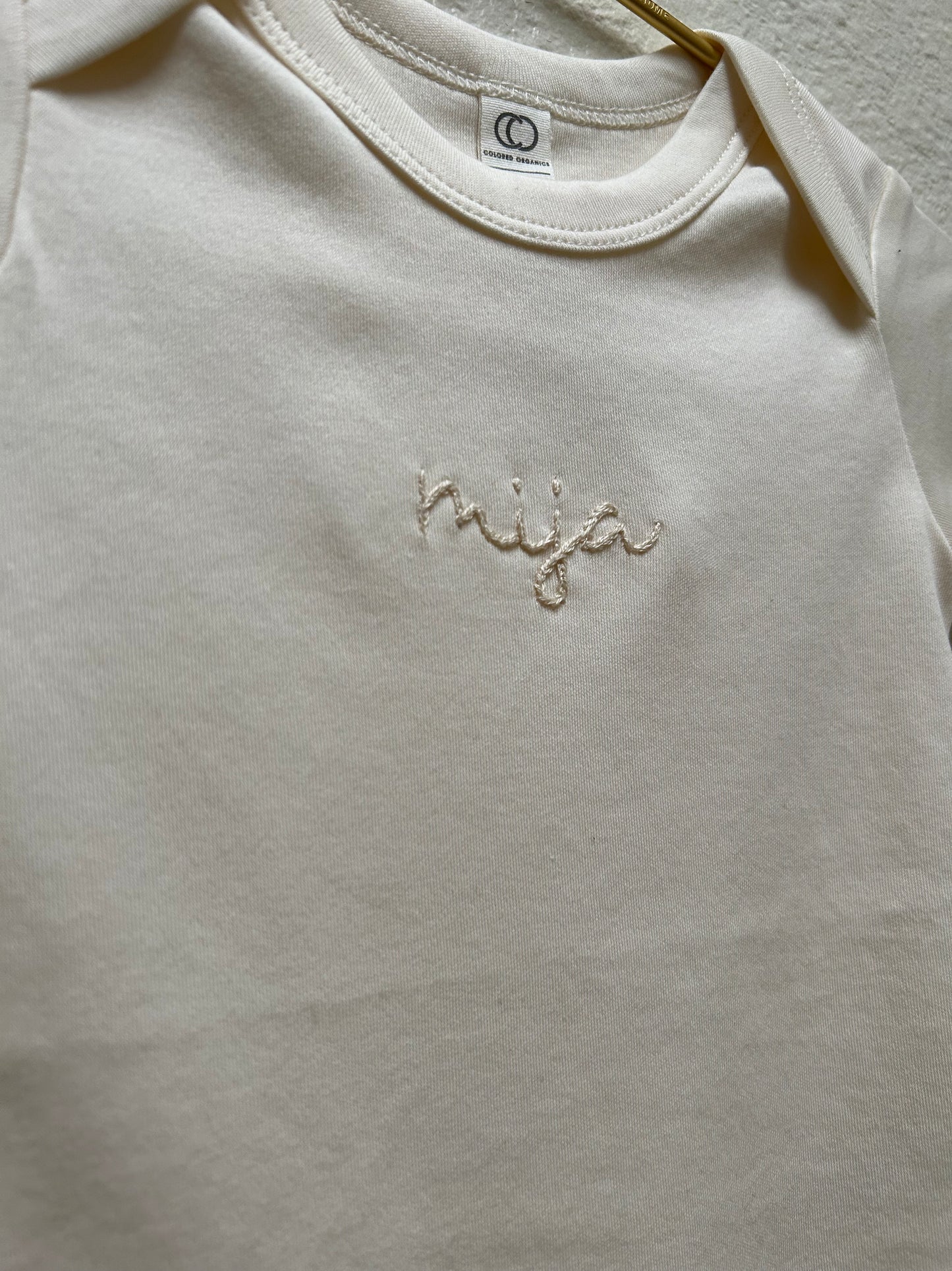HAND EMBROIDERED NAME ONESIE